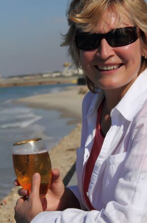 closeup of happy senior woman on beach の写真素材