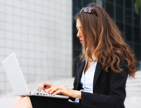 Young beautiful business woman with laptopの写真素材