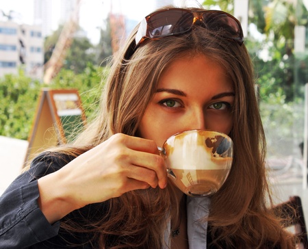 Young beautiful girl drinking coffeeの写真素材