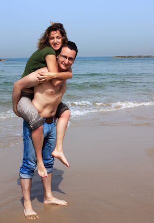 Young happy couple on the beachの写真素材
