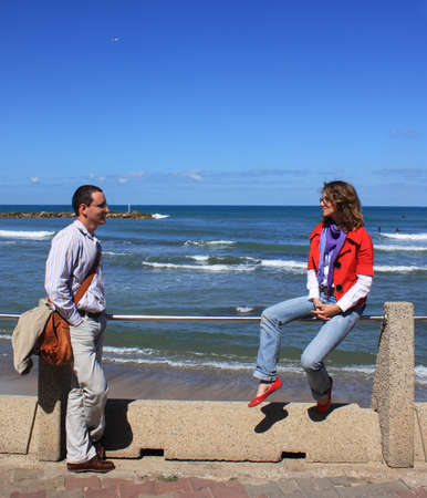 boy and girl talk  Background - the sea の写真素材