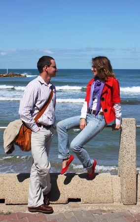 boy and girl talk  Background - the sea の写真素材