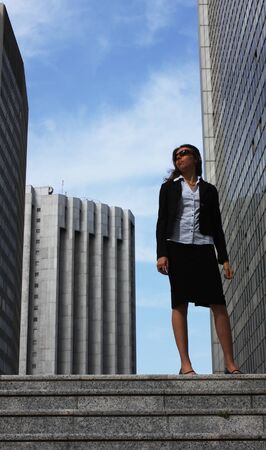Businesswoman sitting on stairs with laptopの写真素材