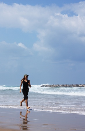 woman during fitness on sea beachの写真素材
