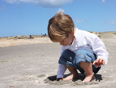 2-year-old child playing on the beachの写真素材