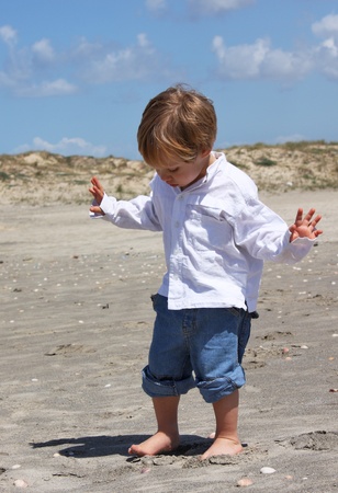 2-year-old child playing on the beachの写真素材