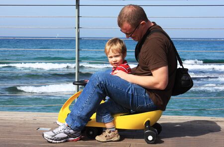 Father and son spend time together at sea の写真素材