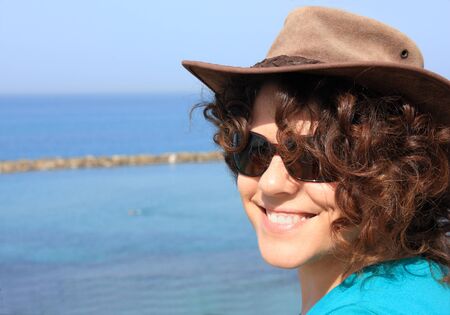 Beautiful brunette and blue sea. Portrait.の写真素材