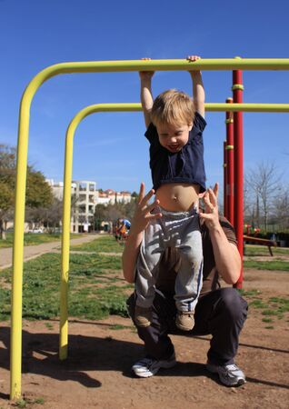 Dad and 2-year-old son at sports trainersの写真素材