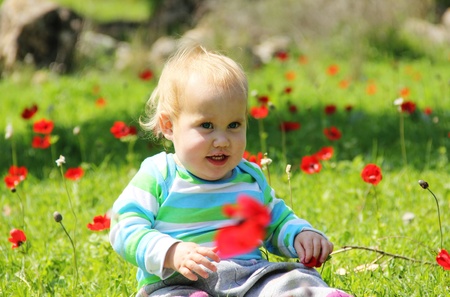 funny toddler in the grassの写真素材