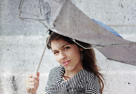 girl with umbrella  Photo in old color image styleの写真素材