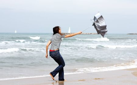 Beautiful girl on the winter beachの写真素材