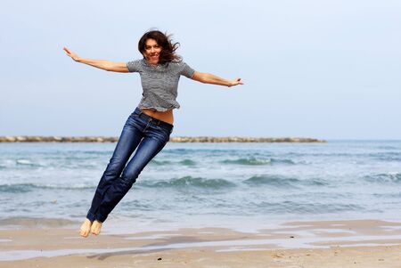 Beautiful girl on the winter beachの写真素材