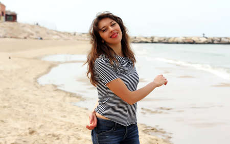 Beautiful girl on the winter beachの写真素材