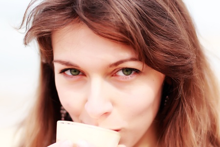 young girl with a cup of coffee  Focus on the eyes の写真素材