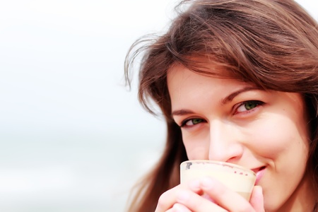young girl with a cup of coffee  Focus on the eyes の写真素材