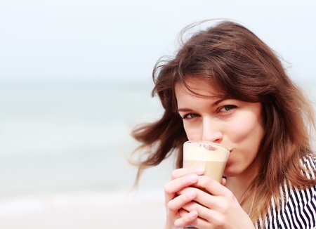 young girl with a cup of coffee  Focus on the eyes の写真素材