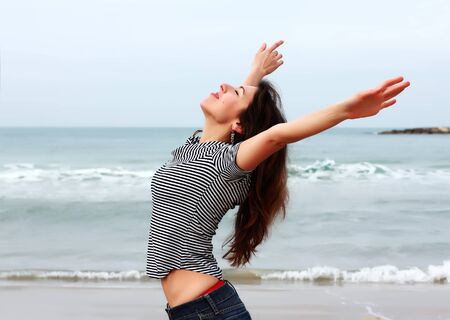 Beautiful girl on the winter beachの写真素材