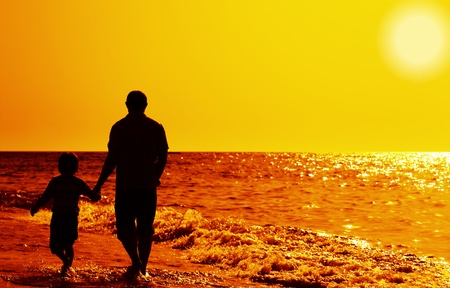 Father and son on the beachの写真素材