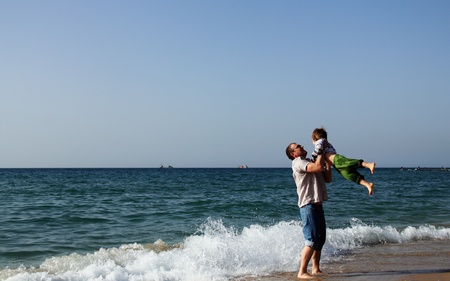 Happy father and son on the beachの写真素材