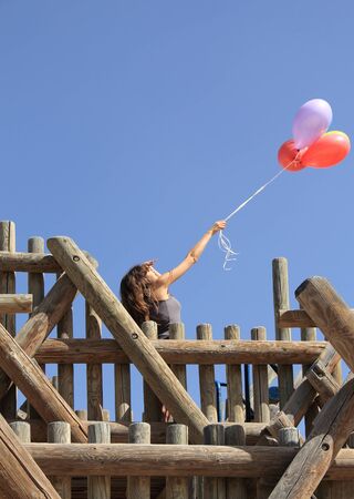 Young woman with colorful balloonsの写真素材