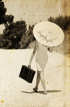 Young woman with umbrella  Photo in old color image styleの写真素材