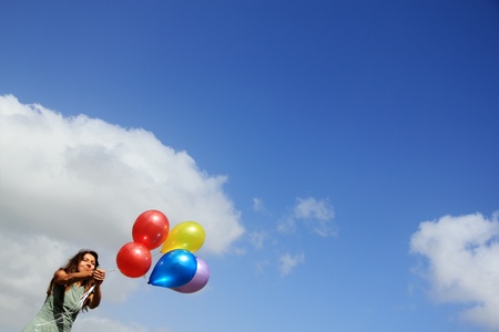 Young woman with colorful balloonsの写真素材