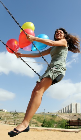 Young woman on a swingの写真素材