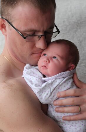 father holds a newborn babyの写真素材