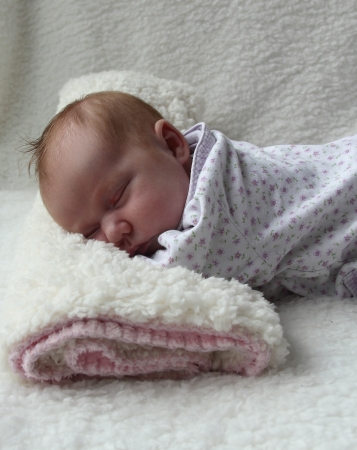 Monthly Redhead girl sleeping on a white blanketの写真素材