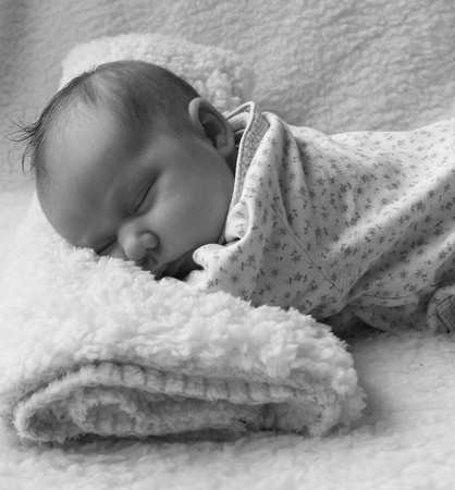 Monthly Redhead girl sleeping on a white blanketの写真素材