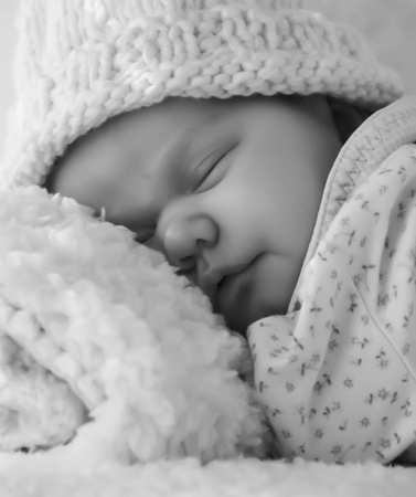 Monthly Redhead baby sleeping on a white blanketの写真素材