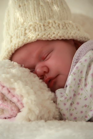 Monthly Redhead baby sleeping on a white blanketの写真素材