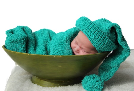 newborn in a knitted cocoon and hat の写真素材