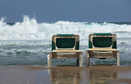 beach loungers on the background of the sea storm  End of the season, winter 