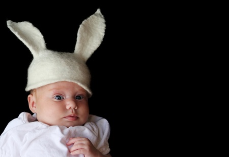 2-month-old baby in a hat with rabbit earsの写真素材