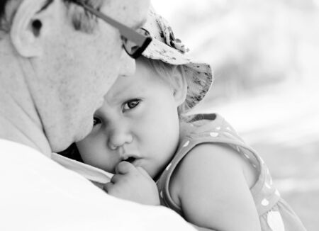 father holding his daughter, focus on the eyesの写真素材