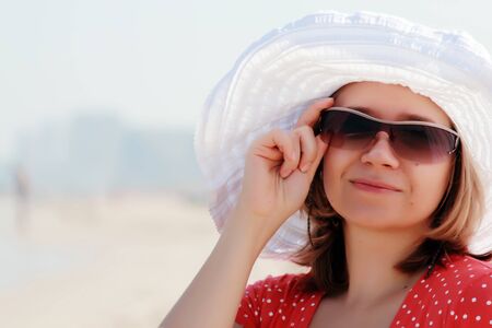 young girl in white hat on the seaの写真素材
