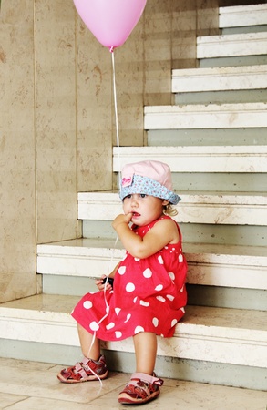 girl in the hat on the stairsの写真素材