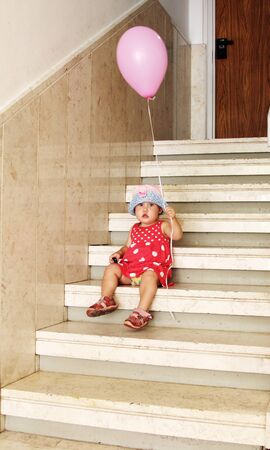 girl in the hat on the stairsの写真素材