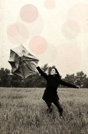 Young woman with umbrella. Photo in old color image style.の写真素材