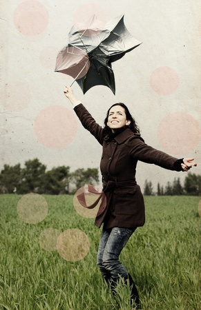 Young woman with umbrella  Photo in old color image style の写真素材