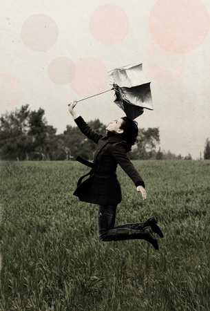 Young woman with umbrella in old color image style の写真素材