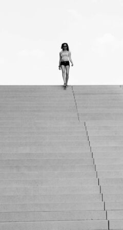 yound woman at the end of the long ladderの写真素材