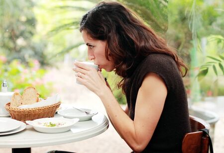 Beautiful 35 years old woman drinking her morning coffeeの写真素材