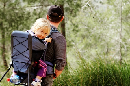 Father hiking with kid on backpackの写真素材
