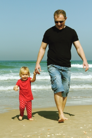 father and daughter on the beachの写真素材