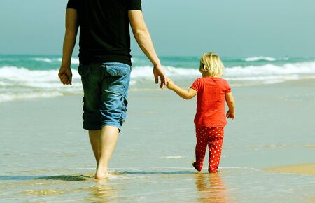 father and daughter on the beachの写真素材