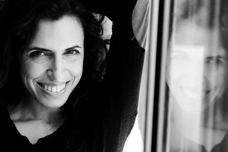 Portrait of beautiful woman near the windowの写真素材