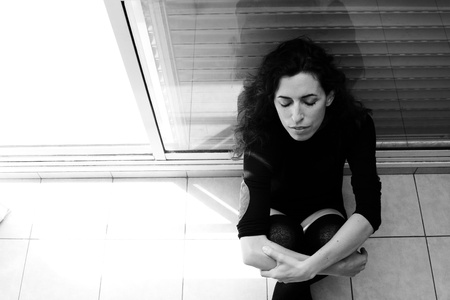 Portrait of beautiful woman near the windowの写真素材